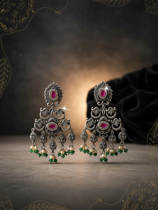 Aurevia Fashion Jewellery Jhansi Heritage oxidized silver earrings with pink stones, pearls, and green bead accents.