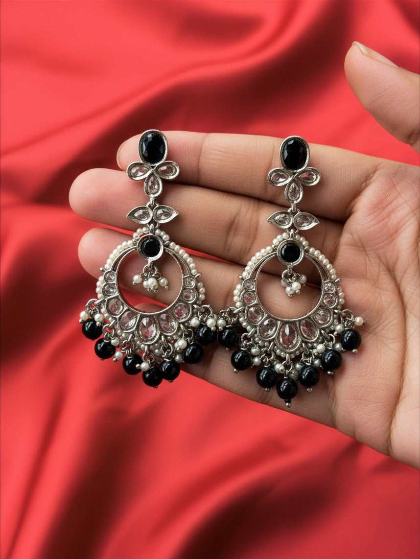 Aurevia Fashion Jewellery Noorika black chandbali earrings with crescent moon design, black beads, and pearl accents.
