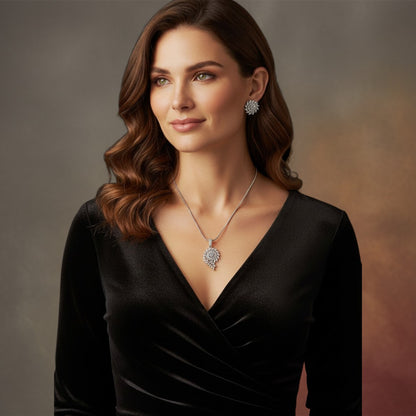Aurevia Fashion Jewellery crystal vine pendant necklace and matching stud earrings worn by a woman in a black dress.