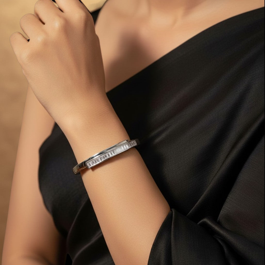 Aurevia Fashion Jewellery channel set cubic zirconia bangle in polished stainless steel worn on a woman's wrist
