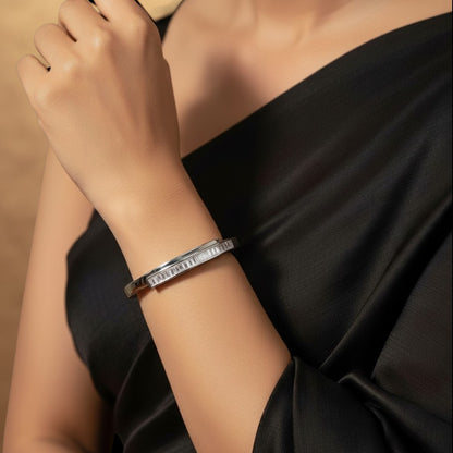Aurevia Fashion Jewellery channel set cubic zirconia bangle in polished stainless steel worn on a woman's wrist