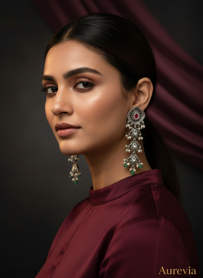 Aurevia Fashion Jewellery Jhansi Aadhya long silver drop earrings with red stone, pearls, and green bead accents.