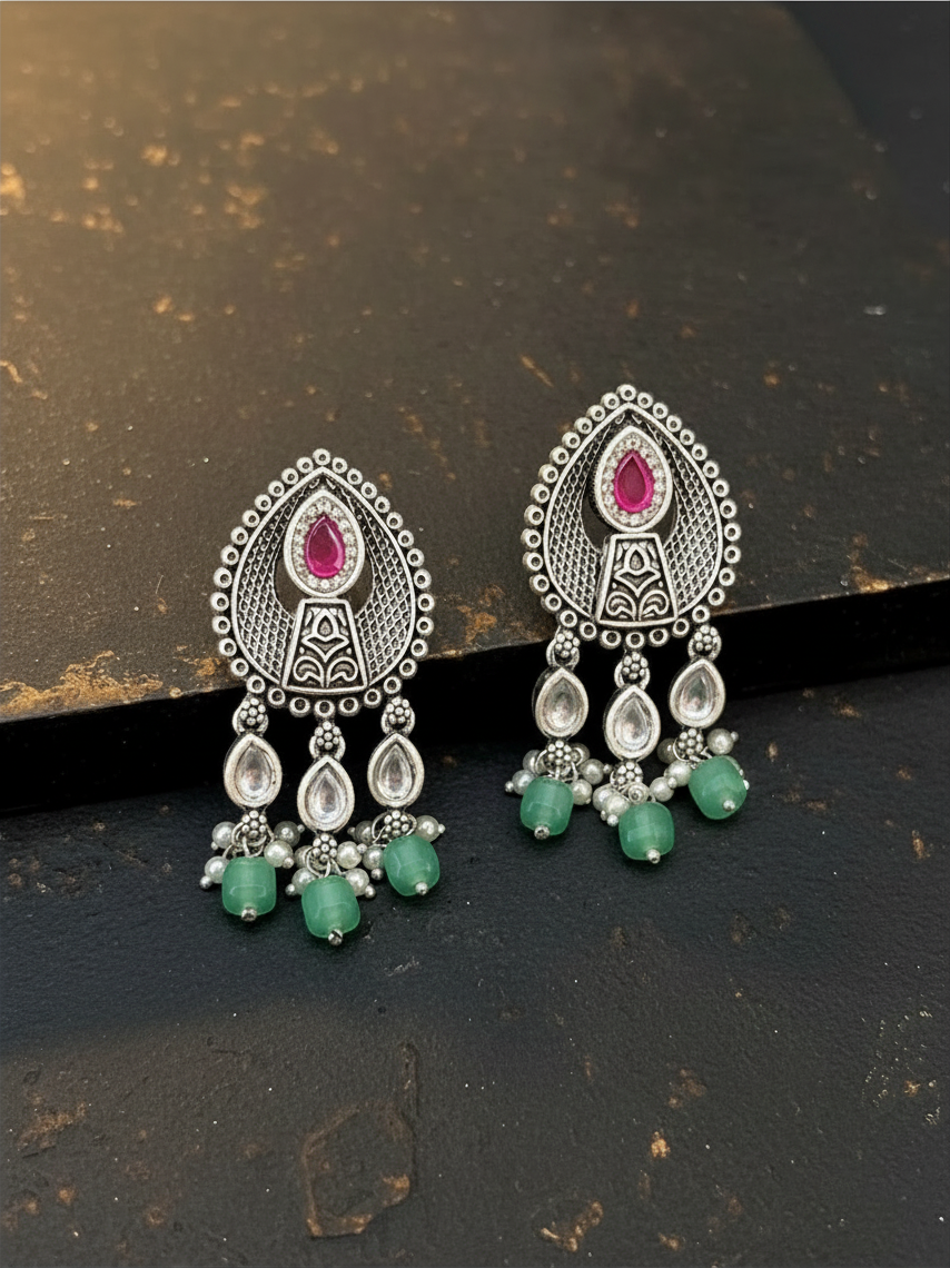 Aurevia Fashion Jewellery Jhansi Aura oxidized silver drop earrings with pink stones, white pearls, and green beads.