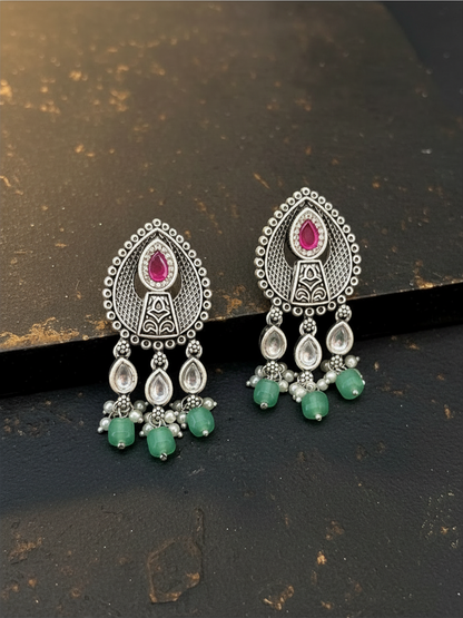 Aurevia Fashion Jewellery Jhansi Aura oxidized silver drop earrings with pink stones, white pearls, and green beads.