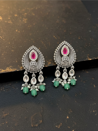 Aurevia Fashion Jewellery Jhansi Aura silver-toned drop earrings with pink stones, clear crystals, and green beads.