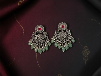 Aurevia Fashion Jewellery Jhansi Grace oxidized silver earrings with pink center stones and hanging green beads.