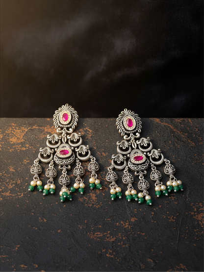 Aurevia Fashion Jewellery Jhansi Heritage silver oxidized earrings with pink stones, white pearls, and green beads.