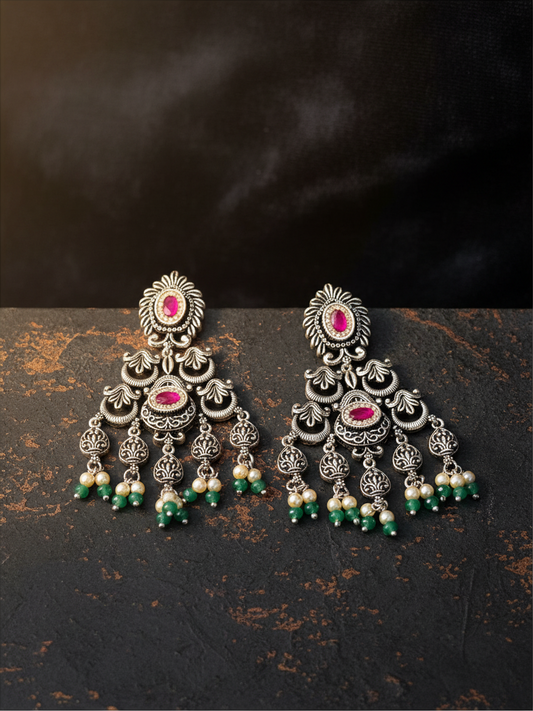 Aurevia Fashion Jewellery Jhansi Heritage silver oxidized earrings with pink stones, white pearls, and green beads.