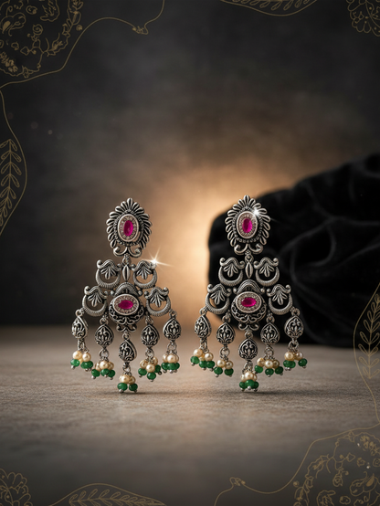 Aurevia Fashion Jewellery Jhansi Heritage oxidized silver earrings with pink stones, pearls, and green bead accents.