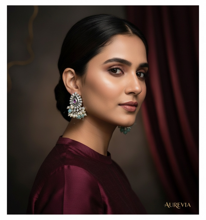 Aurevia Fashion Jewellery Jhansi Majesty teardrop earrings with pink stone, pearls, and mint beads on a woman