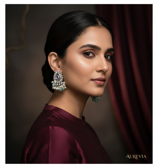 Aurevia Fashion Jewellery Jhansi Majesty teardrop earrings with pink stone, pearls, and mint beads on a woman