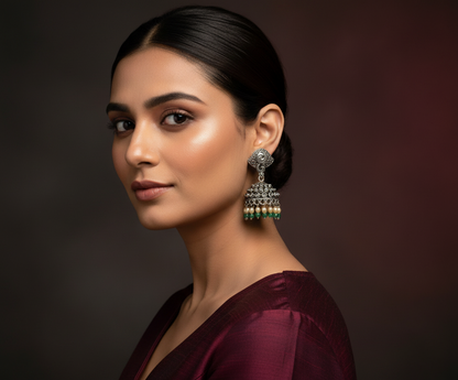 Aurevia Fashion Jewellery Jhansi Noor silver jhumka earrings with green and cream beads worn by a woman