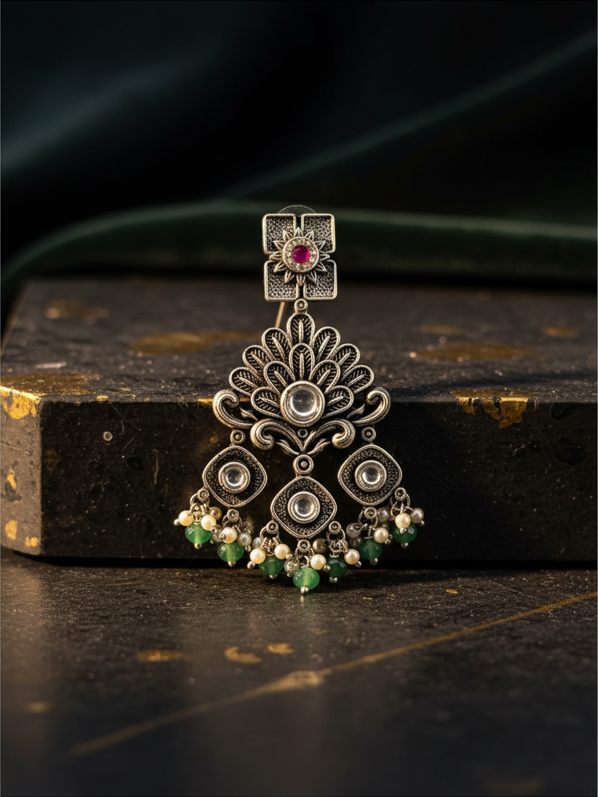 Aurevia Fashion Jewellery Jhansi Regal oxidized silver earring with pink stone, green beads, and pearl accents.