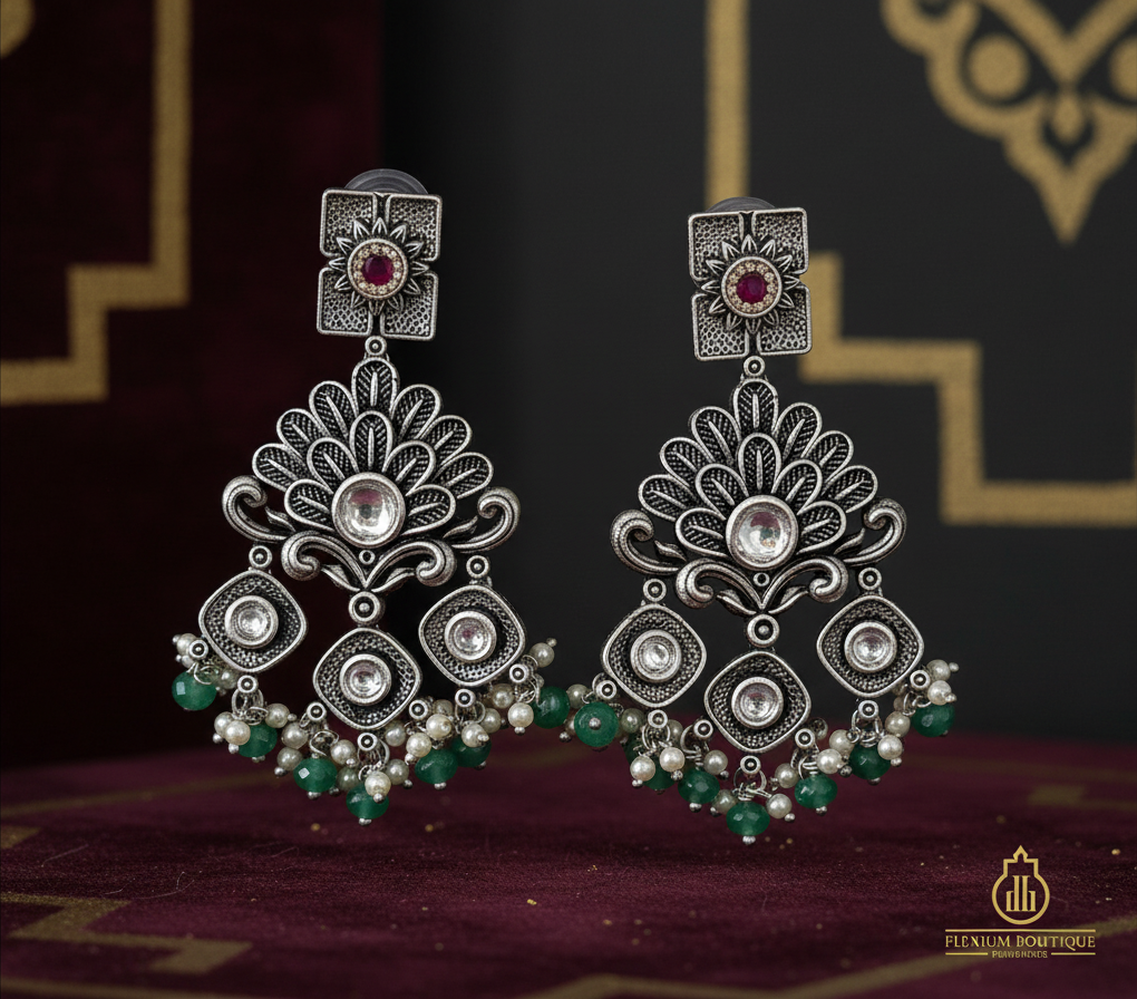 Aurevia Fashion Jewellery Jhansi Regal oxidized silver chandelier earrings with pink stones, pearls, and green beads.