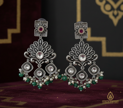 Aurevia Fashion Jewellery Jhansi Regal oxidized silver chandelier earrings with pink stones, pearls, and green beads.