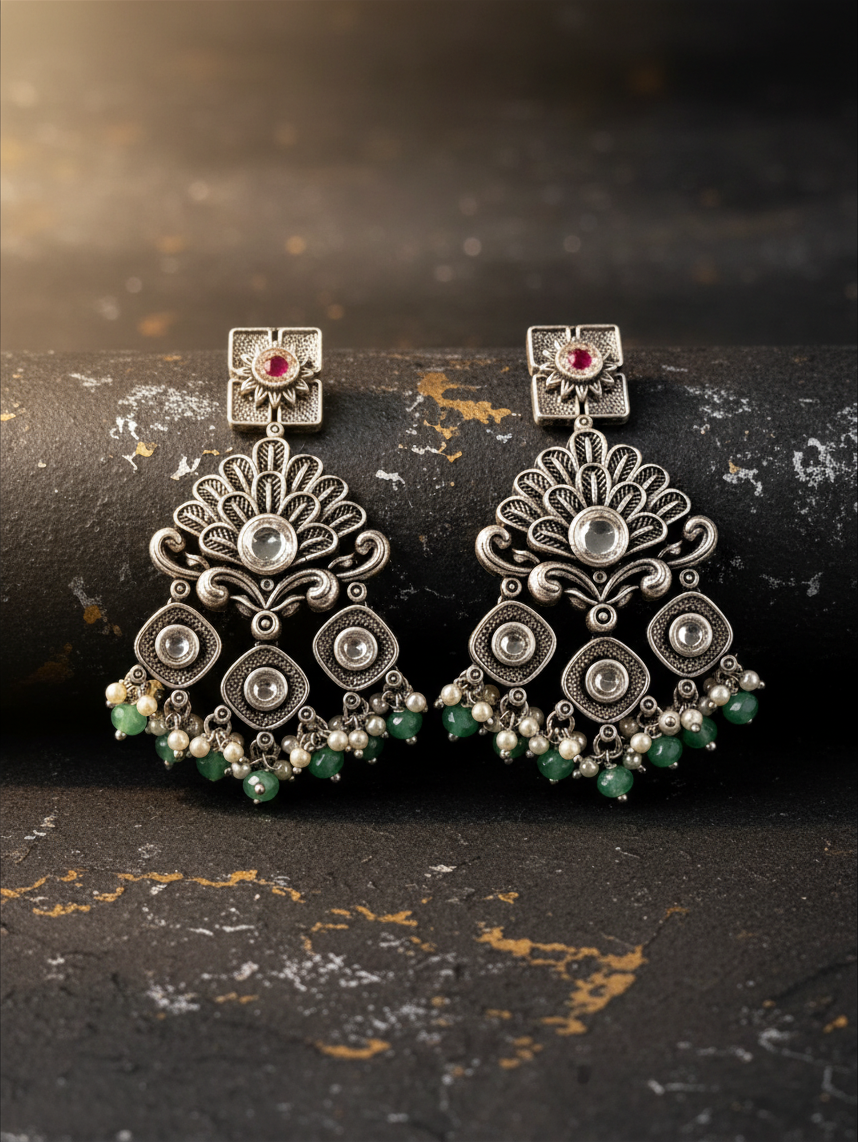 Aurevia Fashion Jewellery Jhansi Regal silver-toned statement earrings with intricate filigree, pearls, and green beads