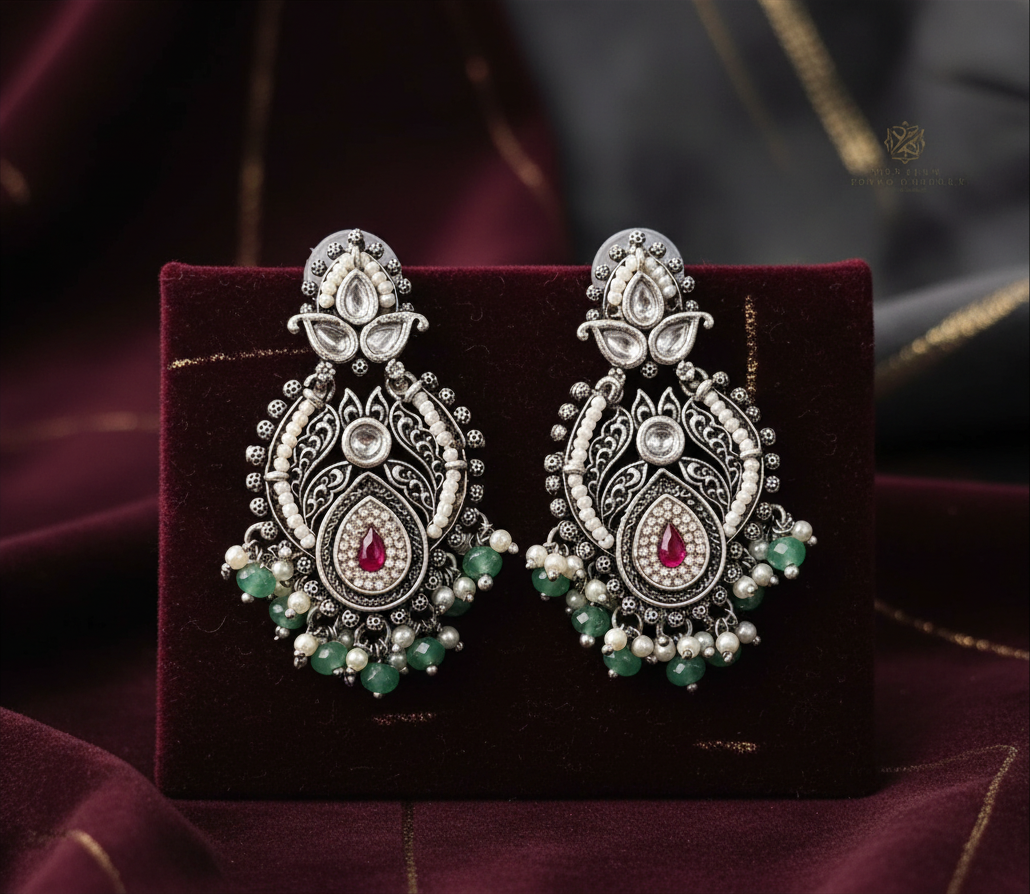 Aurevia Fashion Jewellery Jhansi Royale silver plated earrings with red stones, white pearls, and green beads.