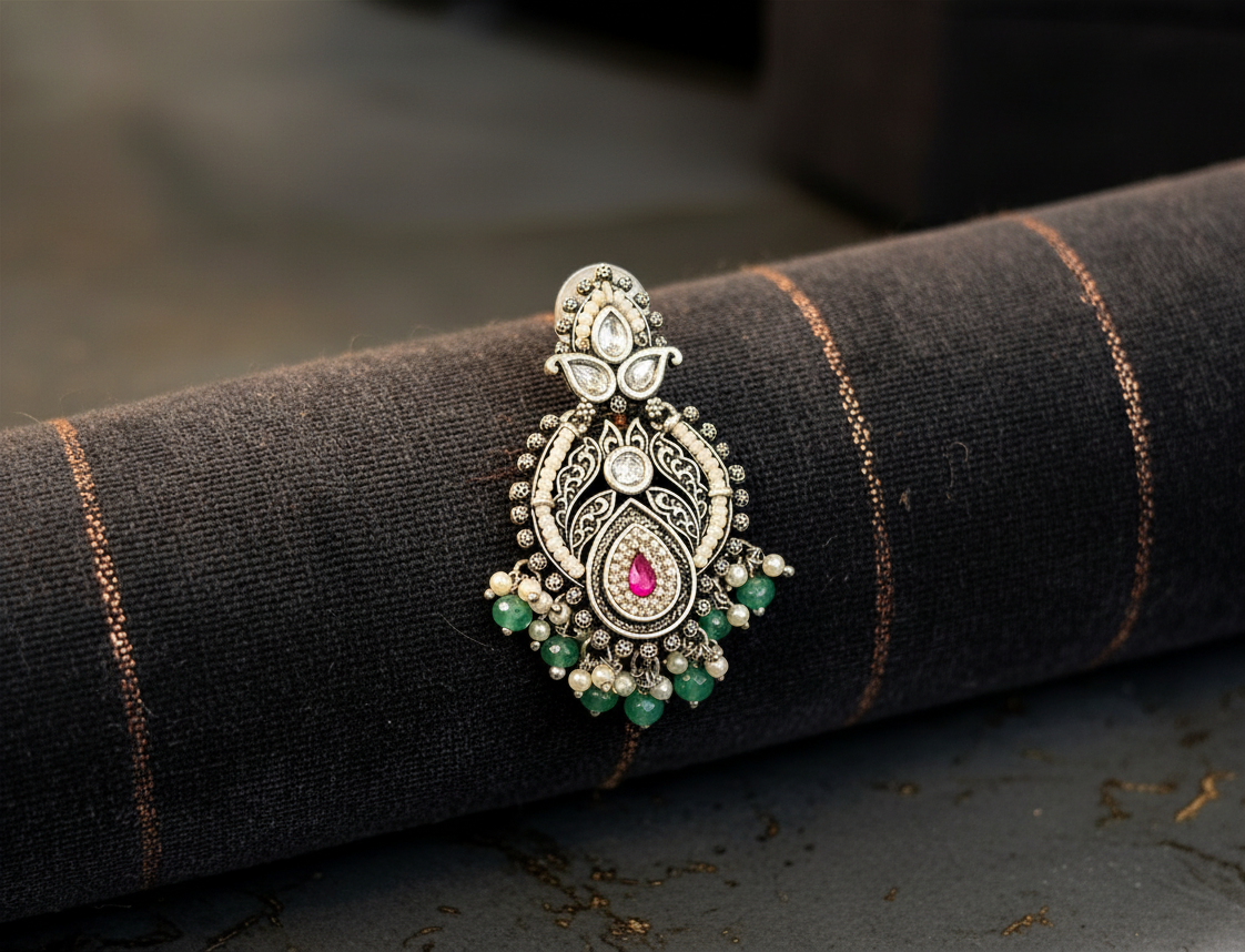 Aurevia Fashion Jewellery Jhansi Royale silver earring with pink stone, green beads, and pearl accents on dark fabric