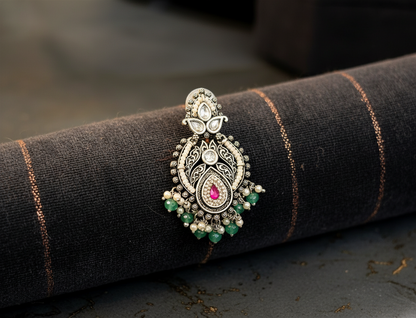 Aurevia Fashion Jewellery Jhansi Royale silver earring with pink stone, green beads, and pearl accents on dark fabric