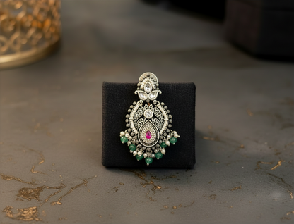Aurevia Fashion Jewellery Jhansi Royale silver-toned earring with intricate filigree, pink stone, and green beads.