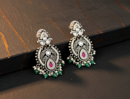 Aurevia Fashion Jewellery Jhansi Royale silver-toned drop earrings with pink stones, white pearls, and green beads.