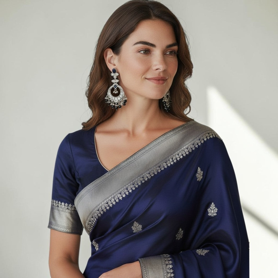 Aurevia Fashion Jewellery Noorika black crescent moon chandbali earrings worn by a woman in a navy blue silk saree.