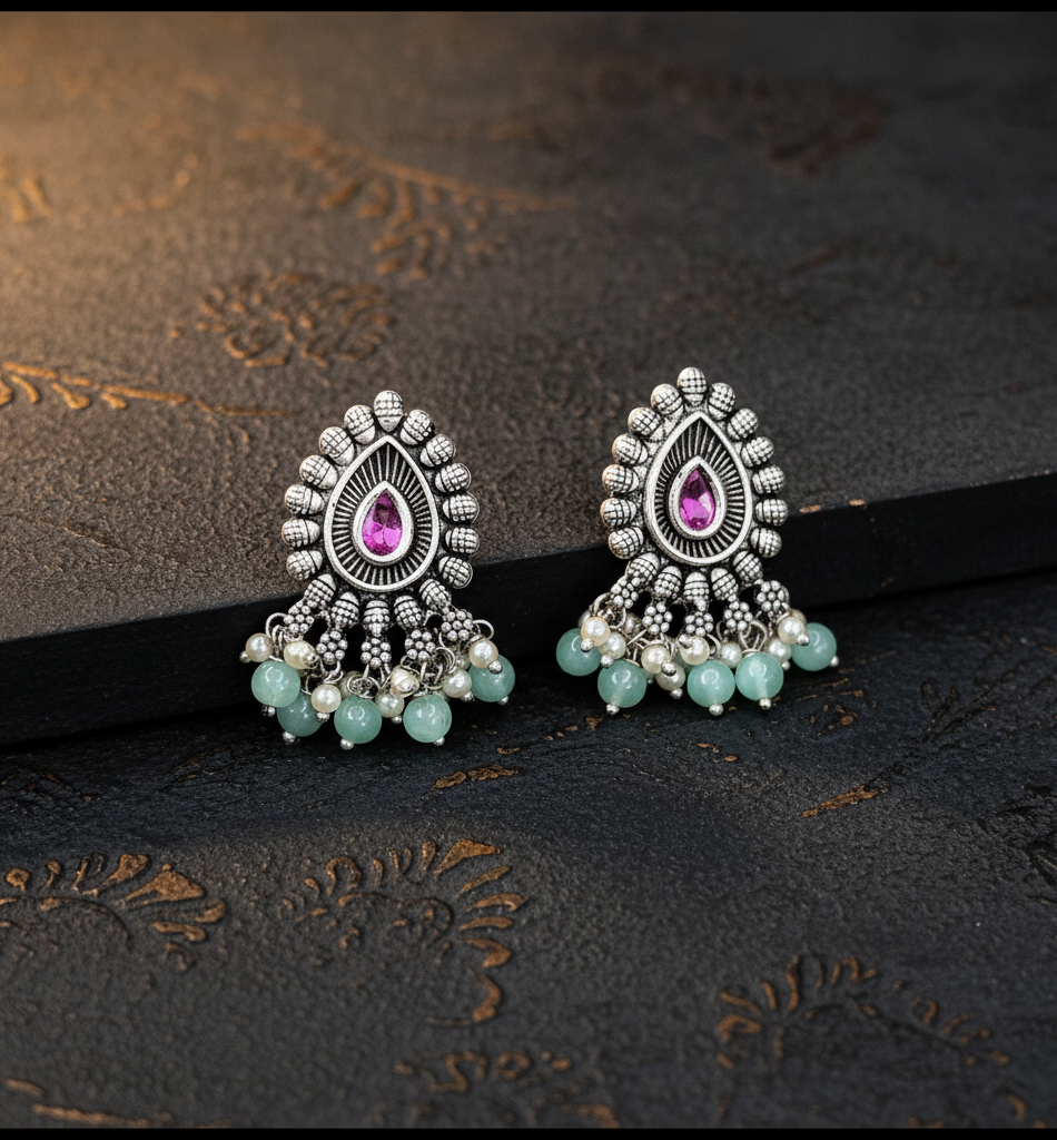 Aurevia Fashion Jewellery Jhansi Majesty oxidized silver earrings with pink teardrop stones and mint green beads.