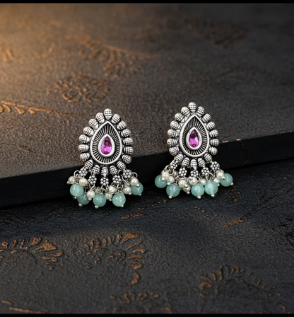 Aurevia Fashion Jewellery Jhansi Majesty oxidized silver earrings with pink teardrop stones and mint green beads.