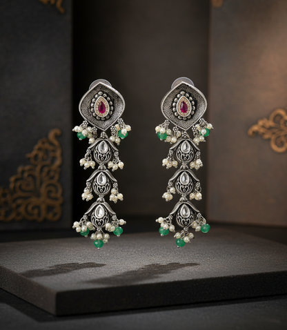 Aurevia Fashion Jewellery Jhansi Aadhya oxidized silver drop earrings with ruby stones, white pearls, and green beads.